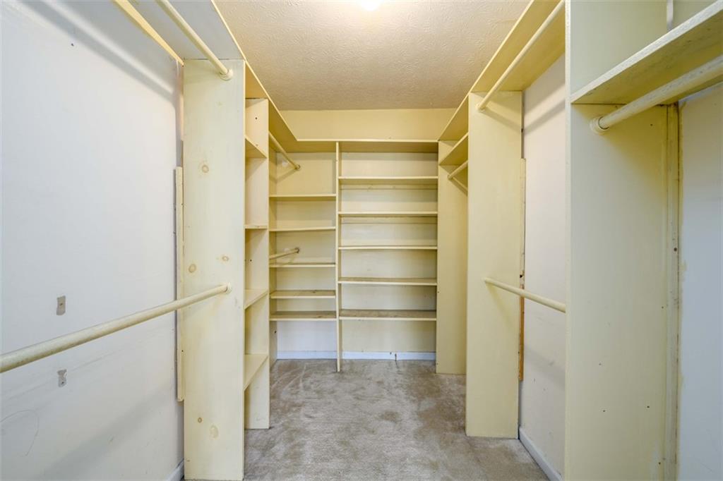 6420 Phillips Place Lithonia, GA 30058 - Photo 25 of 40 a view of walk in closet with empty racks