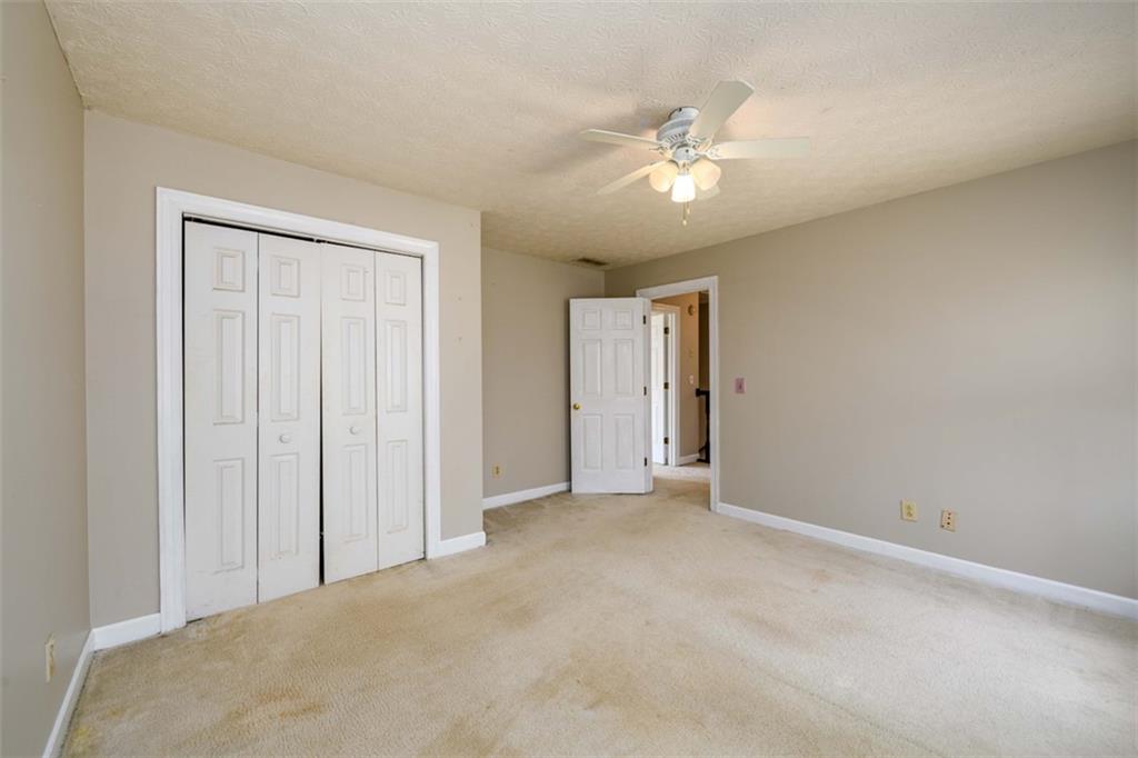 6420 Phillips Place Lithonia, GA 30058 - Photo 31 of 40 a view of an empty room with a chandelier fan