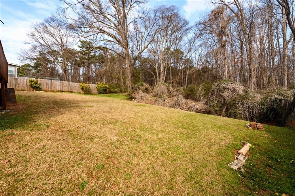 6420 Phillips Place Lithonia, GA 30058 - Photo 36 of 40 a view of yard with trees in the background