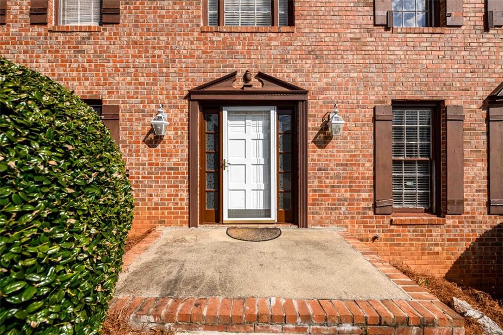 6420 Phillips Place Lithonia, GA 30058 - Photo 4 of 40 a front view of a house with a garden