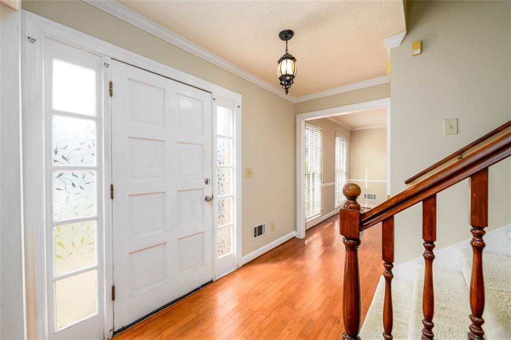 6420 Phillips Place Lithonia, GA 30058 - Photo 5 of 40 a very nice looking room with wooden floor and stairs