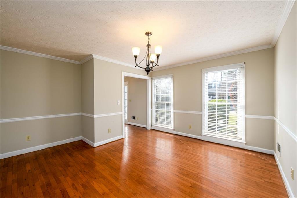 6420 Phillips Place Lithonia, GA 30058 - Photo 10 of 40 wooden floor in an empty room with a window