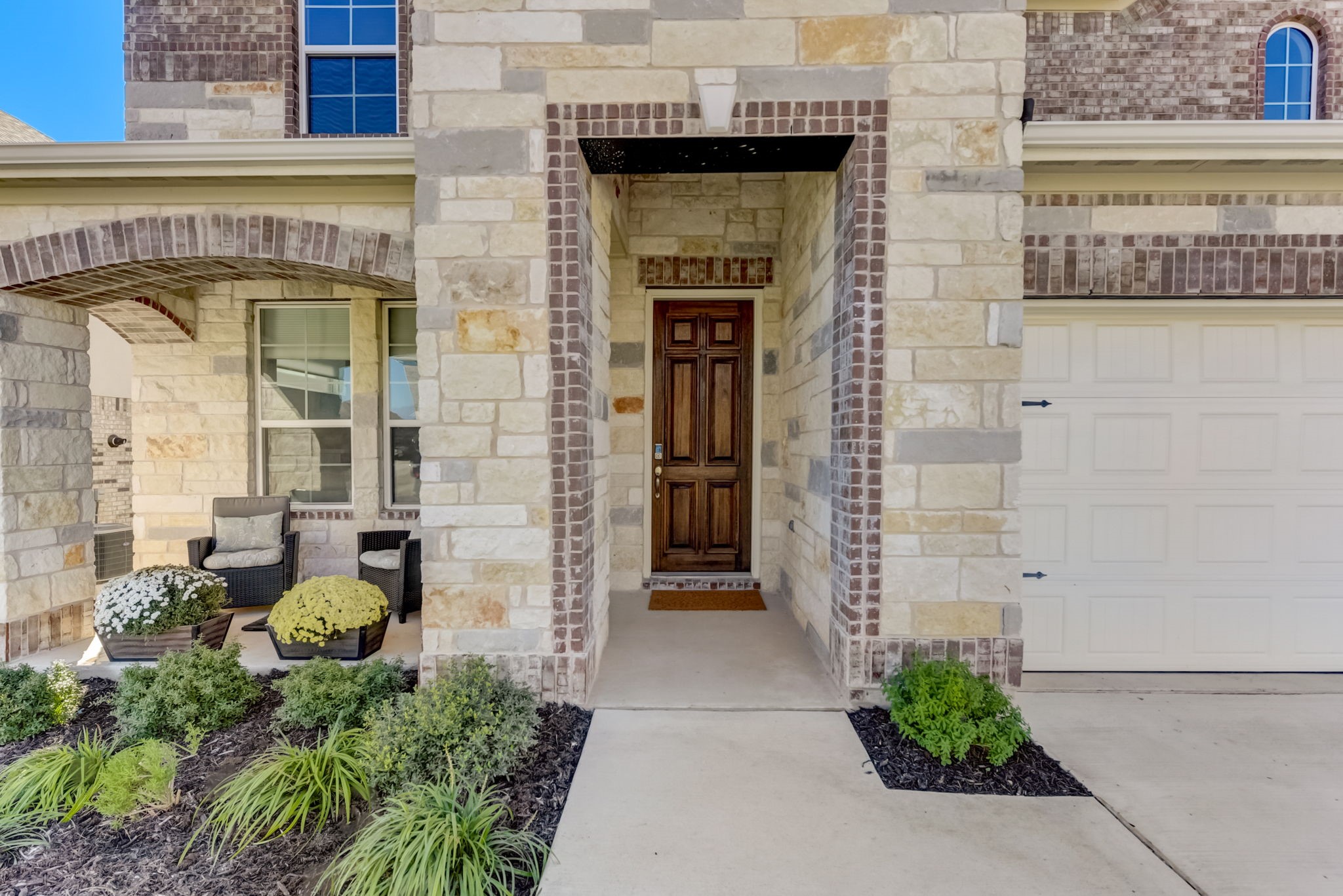 2121 Prairie Oaks Drive Georgetown, TX 78628 - Photo 11 of 40 a front view of a building with potted plants
