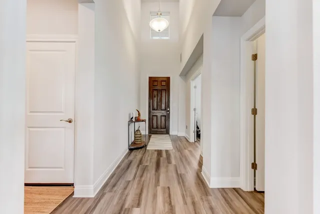 a view of a hallway with wooden floor