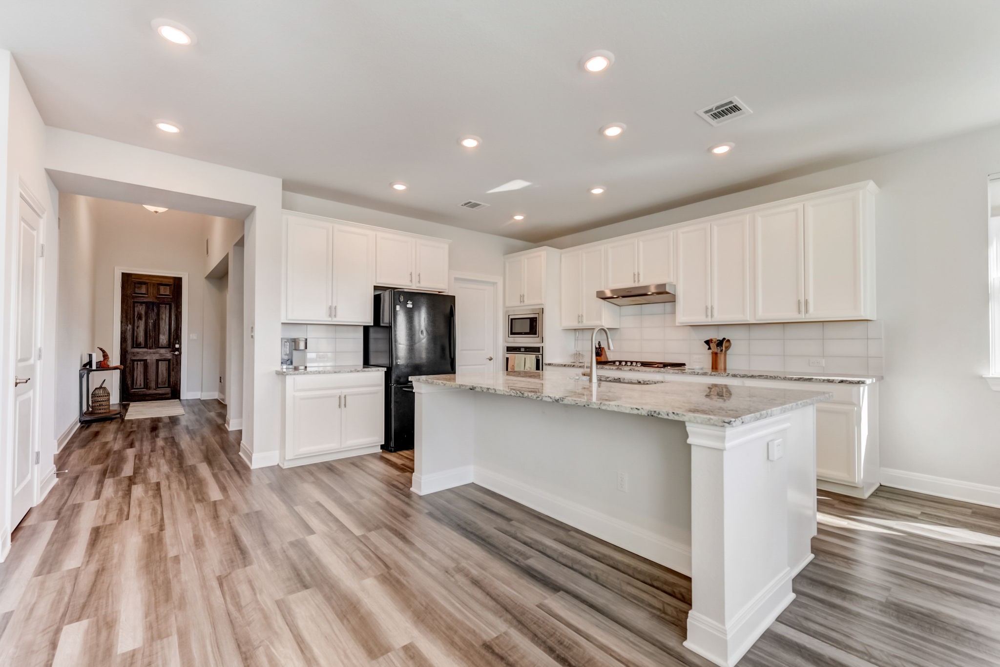 2121 Prairie Oaks Drive Georgetown, TX 78628 - Photo 15 of 40 a kitchen with stainless steel appliances a refrigerator sink and cabinets