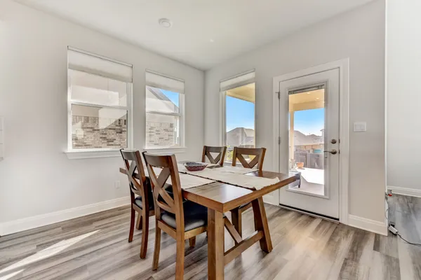 a view of a dining room with furniture window and wooden floor