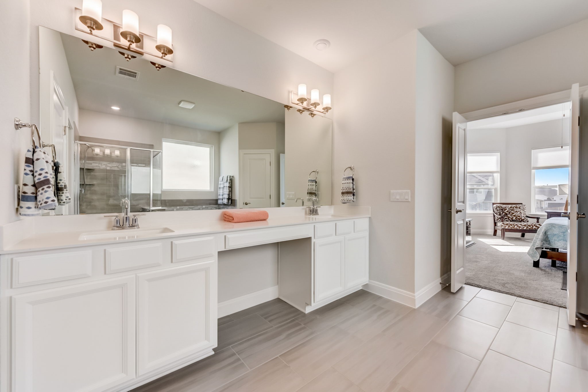 2121 Prairie Oaks Drive Georgetown, TX 78628 - Photo 19 of 40 a spacious bathroom with a double vanity sink a mirror a vanity and a bathtub