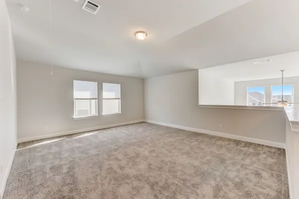 an empty room with a empty space and windows