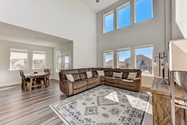 a living room with furniture and wooden floor