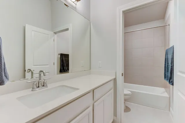 a bathroom with double vanity sinks and a mirror