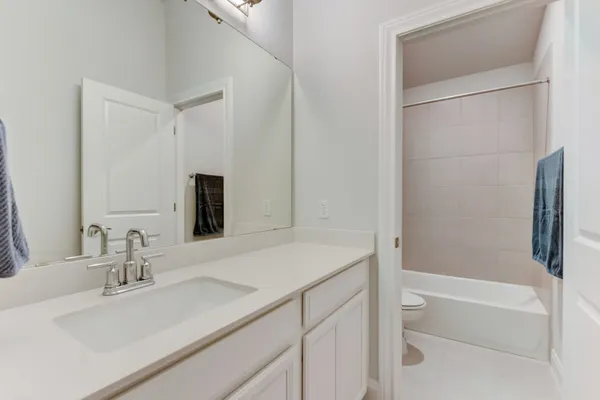 a bathroom with double vanity sinks and a mirror