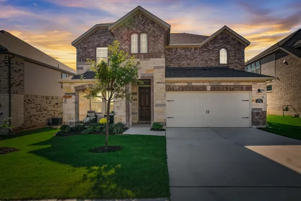 a front view of a house with a yard