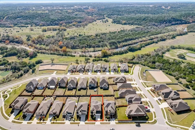 an aerial view of residential houses with outdoor space