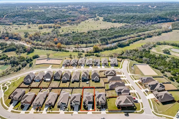 an aerial view of residential houses with outdoor space