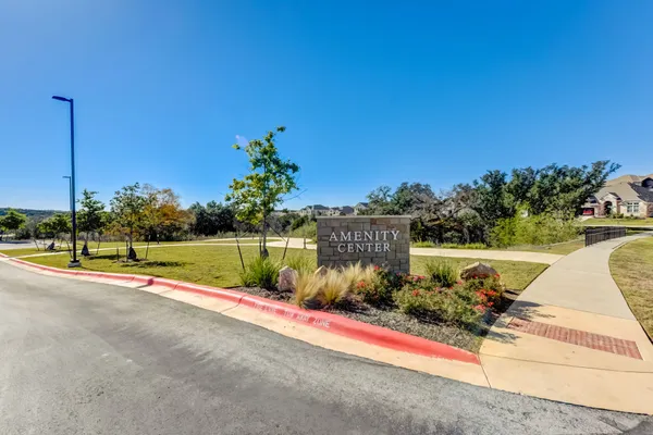 a front view of a house with a garden and plants