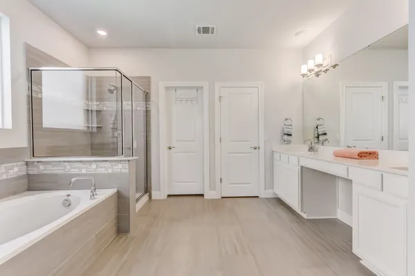 a bathroom with a bathtub a sink and a shower