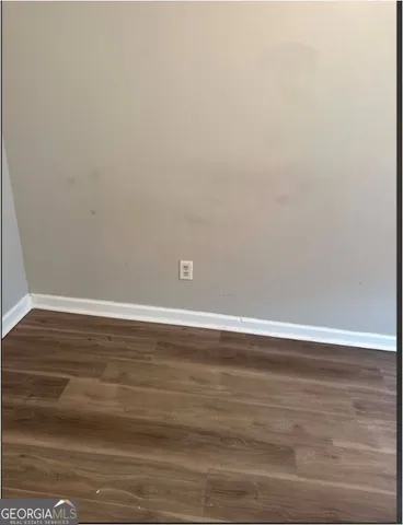 a view of a room with wooden floor