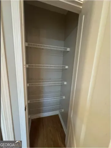 a view of walk in closet with empty racks