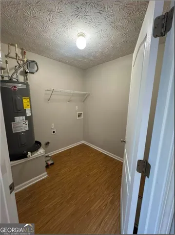 a view of a room with wooden floor and staircase