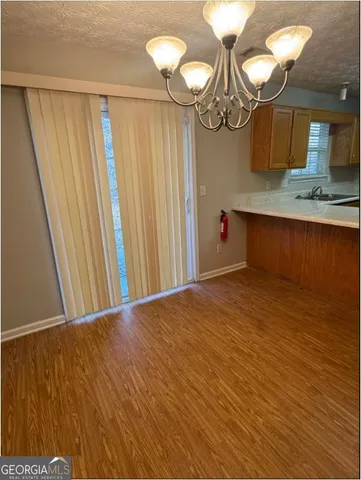 a view of a room with wooden floor