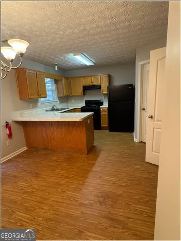 a kitchen with stainless steel appliances granite countertop a sink and cabinets