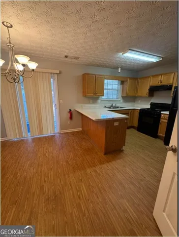 a kitchen with stainless steel appliances granite countertop a sink dishwasher stove and refrigerator