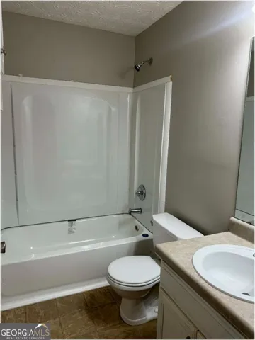 a bathroom with a toilet a sink and bathtub
