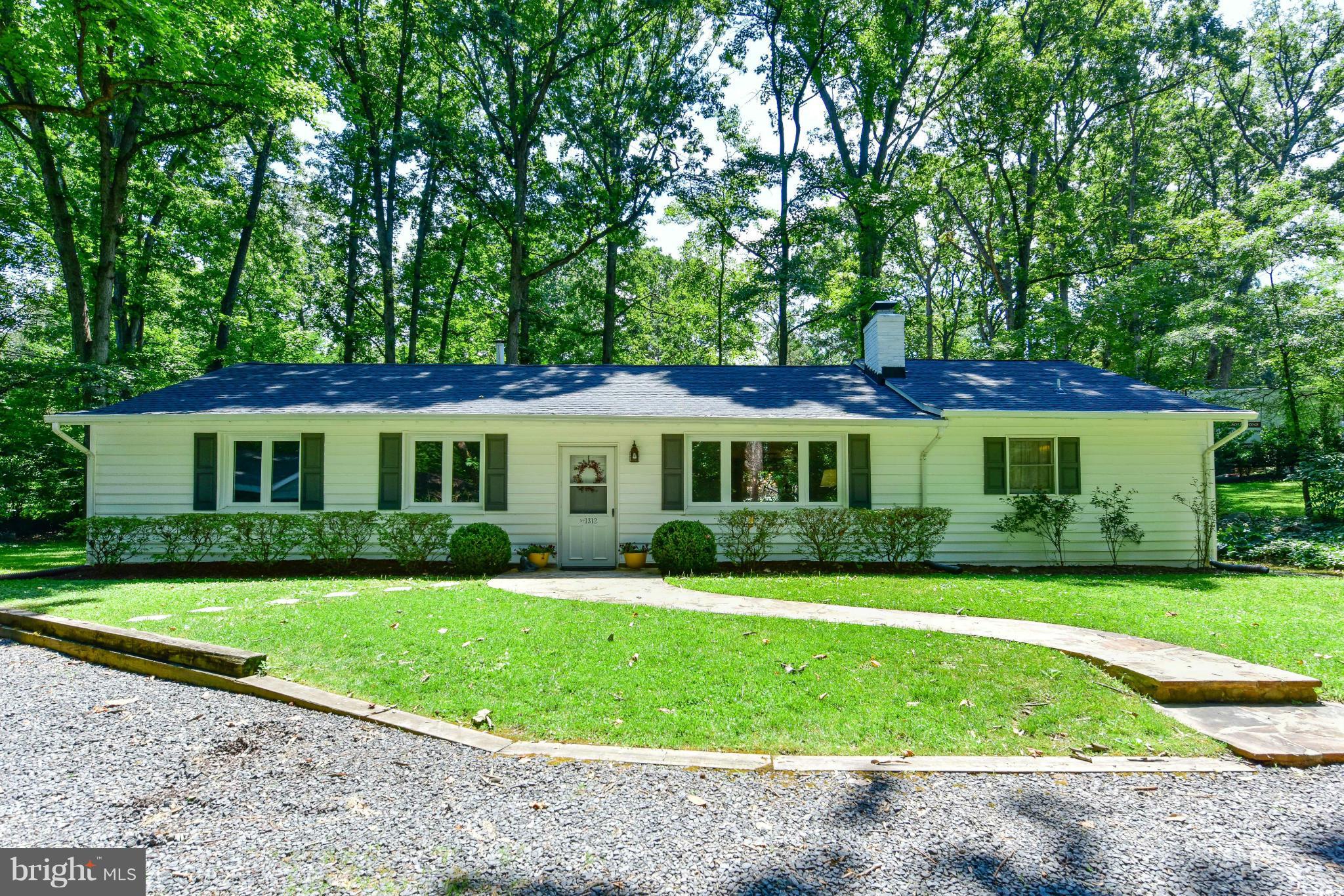 1312 Namassin Road Alexandria, VA 22308 - Photo 1 of 30 a front view of a house with a garden