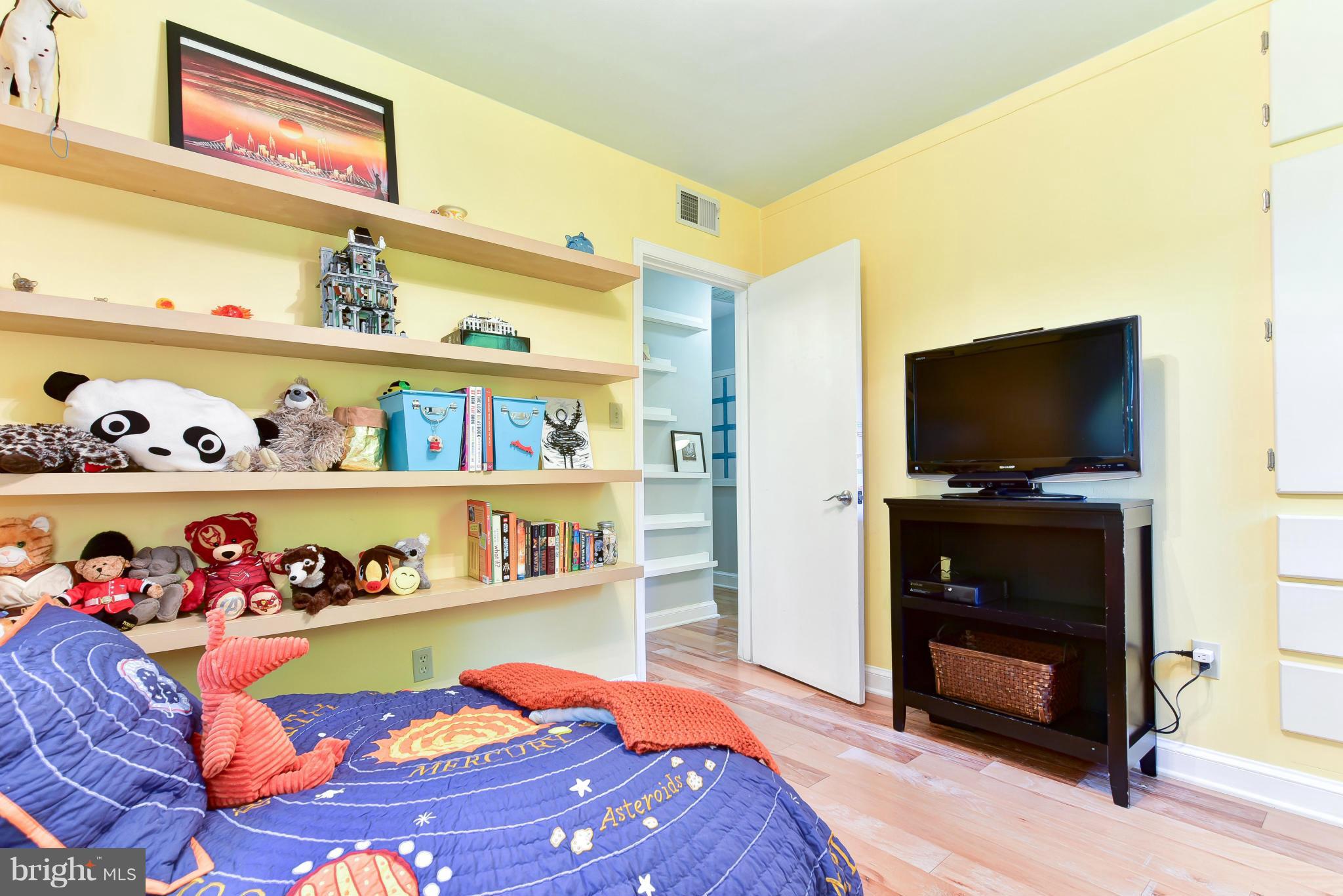 1312 Namassin Road Alexandria, VA 22308 - Photo 16 of 30 a bedroom with a bed and flat screen tv