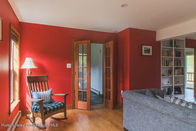 a living room with furniture a flat screen tv and lamp