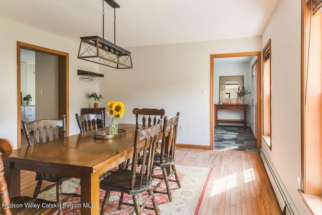 a view of a dining room with furniture and wooden floor