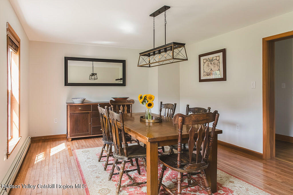 1457 N Road Blenheim, NY 12131 - Photo 20 of 43 a view of a dining room with furniture and wooden floor