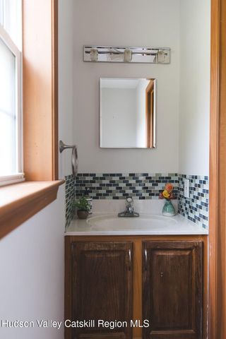 a bathroom with a sink vanity and a mirror