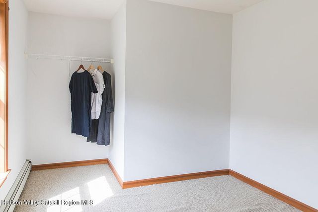 a view of a hallway with wooden floor and a workspace