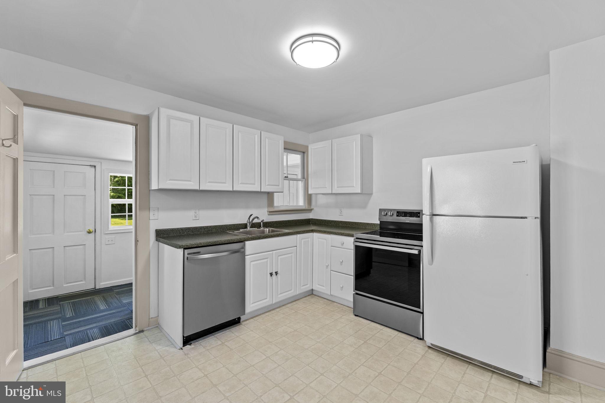 216 Walnut Street Berryville, VA 22611 - Photo 21 of 36 a kitchen with cabinets stainless steel appliances and a counter space