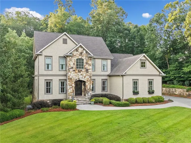 a front view of a house with a yard and garage