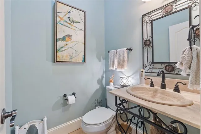 a bathroom with a granite countertop sink a mirror and a shower