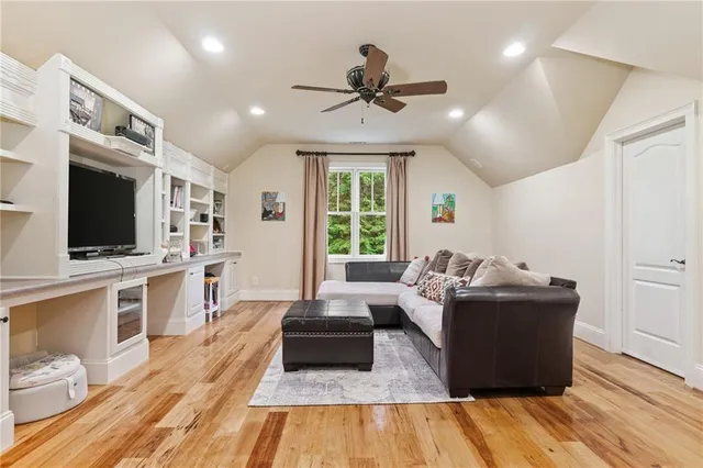 a living room with furniture and large windows