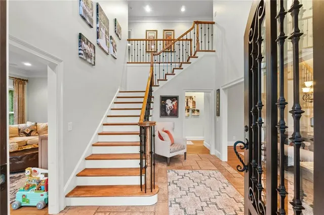 a kitchen with a refrigerator a stove a sink and a dining table with chairs