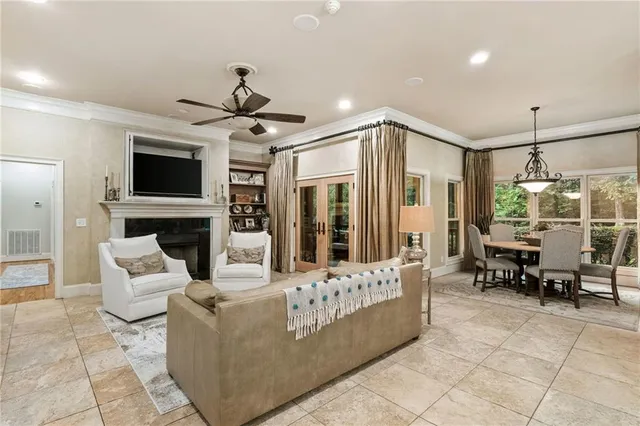 a view of a dining room with furniture a chandelier and wooden floor