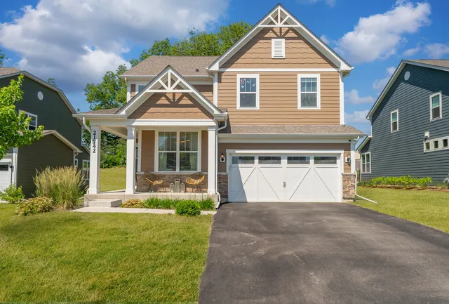 a front view of a house with a yard and garage