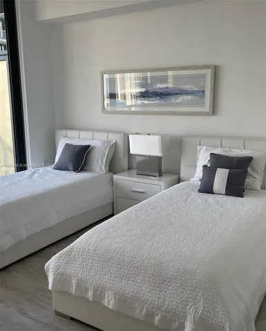 a bedroom with bed and window