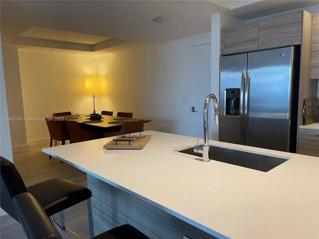 a kitchen with a table and chairs