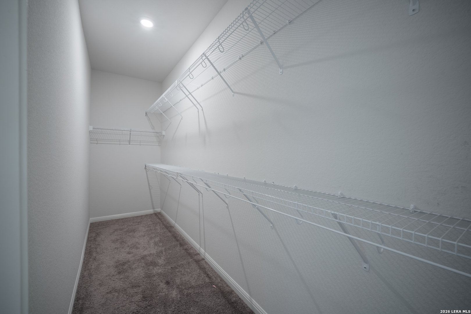 4947 Ranahan Pass St. Hedwig, TX 78152 - Photo 22 of 37 a view of storage and utility room with empty racks