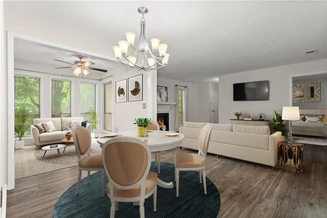 a living room with furniture chandelier and a flat screen tv