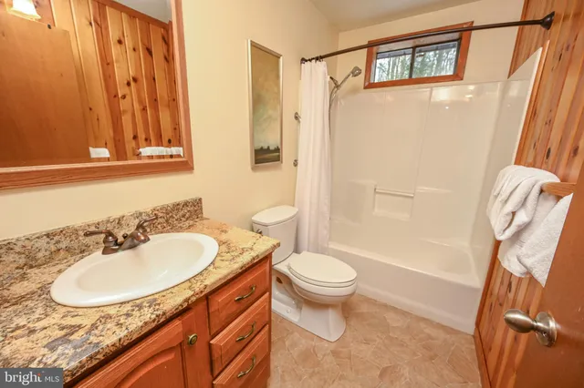 a bathroom with sink mirror and bathtub