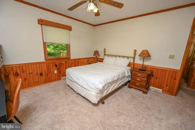 an aerial view of a house with balcony and trees