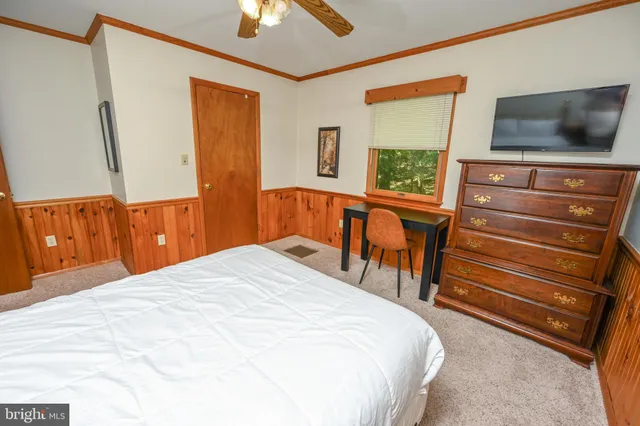 an aerial view of a house with a yard and tree s