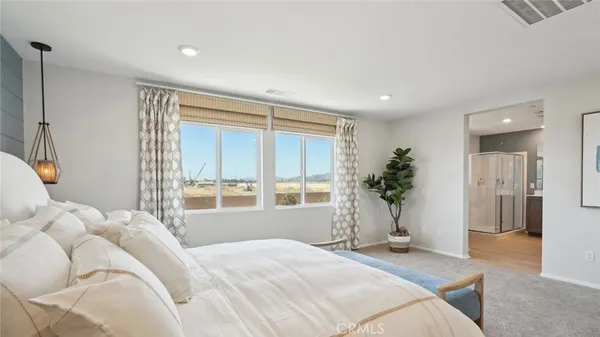 a bedroom with a bed and a large window