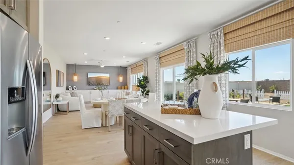a view of kitchen with living room and refrigerator